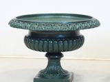 two green vases sitting next to each other on a table