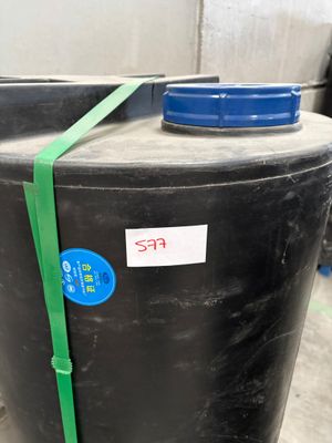 a black barrel with a blue lid and a green strap around it