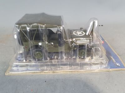 a toy army truck in a clear plastic container