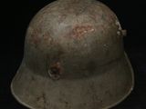 an old military helmet on a black background with a red spot on the helmet