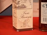 a bottle of wine sitting next to a box of wine