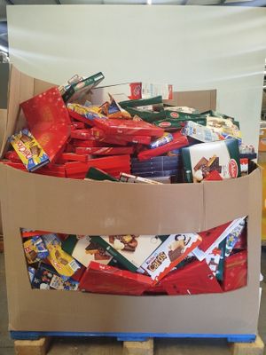 a cardboard box full of candy and candy bars on a pallet