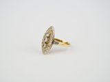 a gold and diamond ring with an oval center stone