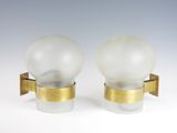 pair of glass and brass sconces with frosted glass globes