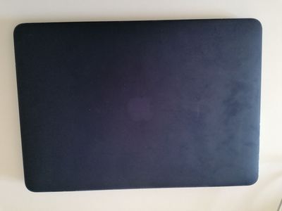 an open laptop computer sitting on top of a white table