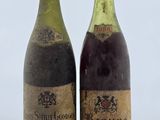 deux bouteilles de vin posées sur une table l'une à côté de l'autre