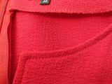 a close up of a red shirt with a zipper on it