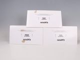 three boxes of white wine sitting on top of a table next to a glass of wine