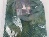 a bag of green yarn on a white surface