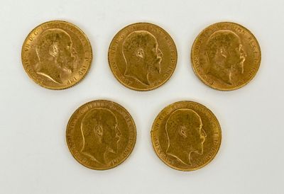four gold sovereigns of different sizes and shapes on a white surface