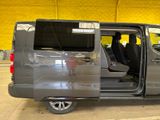 a grey van with its doors open in a garage