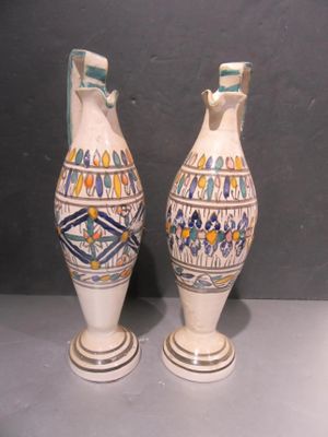 two vases that are sitting on a table
