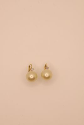 a pair of pearl and diamond earrings