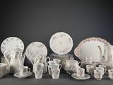 many different types of dishes and cups on the table
