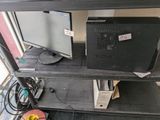 a computer monitor and a monitor monitor sitting on a shelf