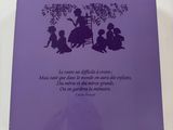 the back cover of a purple book with a picture of a woman and two children