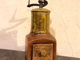 a small coffee grinder sitting on a counter top