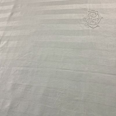 an image of a bed with a white comforter and a white pillow