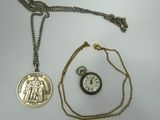 an image of a pocket watch and a coin on a chain