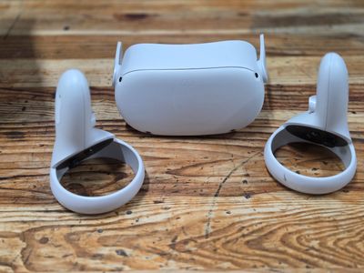 a pair of white ear buds sitting on a wooden table