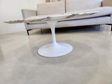 a surfboard on a table in the middle of a living room