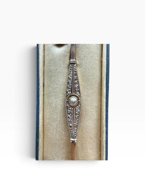 an image of a diamond and pearl bracelet in a box