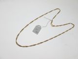 an image of a necklace with a tag on it on a white surface