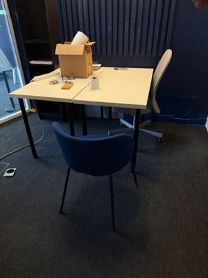 a desk with a chair and a box on it