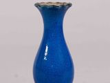 a blue vase that is sitting on a table