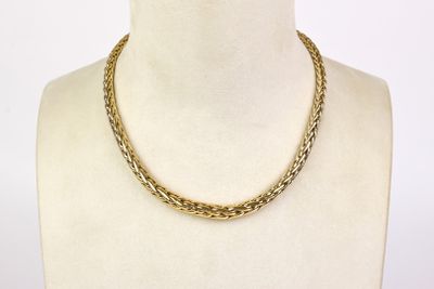 a close up of a mannequin torso with a necklace on it