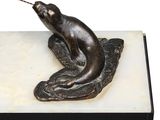 sculpture of a cat on a leaf on a marble base