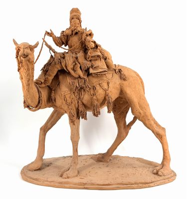statue of a man riding a camel with a child on his back