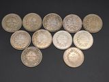 several different types of coins are arranged on a black surface