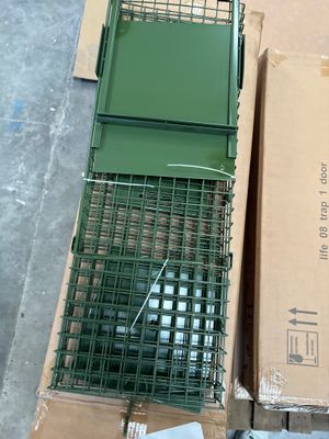a box with a bird in it sitting on the floor next to a box with a bird in it