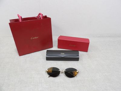 a pair of sunglasses sitting on top of a table next to a red box