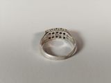 a close up of a silver ring on a white surface
