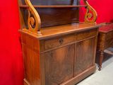 a wooden desk with a red wall in the background