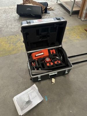 a suitcase with tools in it sitting on the floor
