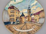 an image of a plate with a picture of a town on it