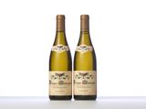 two bottles of wine sitting on top of a white table