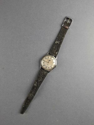 an image of a watch on a gray surface with a black strap