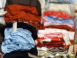 a lot of clothes that are sitting on a table