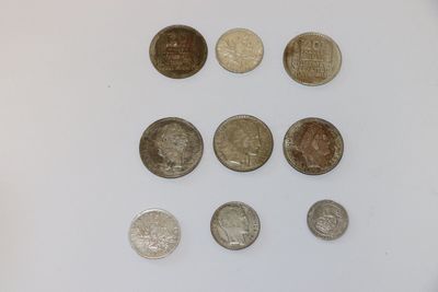 several different coins are arranged in a circle on a white surface
