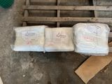 several bags of food sitting on top of a pallet in a warehouse