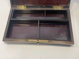 an old wooden box with two compartments sitting on a table