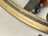 a close up of a person using a knife to cut a piece of wood