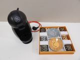 a box of chocolates and a coffee maker on a table