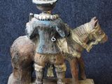 a figurine of a man riding a horse with a dog