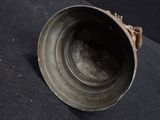 a metal object that is sitting on a black surface