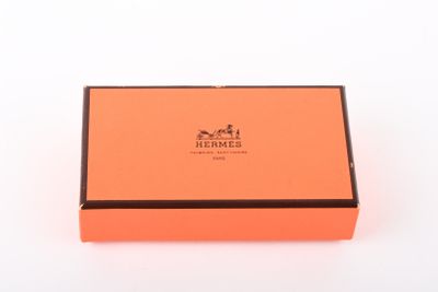 a close up of an orange box on a white surface